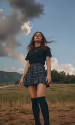 a beautiful young lady in short shorts and knee high boots standing on a grassy area