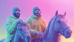 two men wearing winter gear sitting on horses