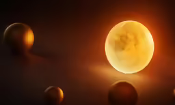 a yellow moon sitting on top of a table next to orange balls