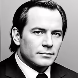 black and white photograph of a man wearing a suit and tie