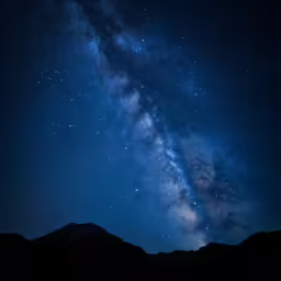 a sky full of stars as seen from the side of a hill
