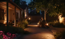 people sitting around and using flashlights on some trees