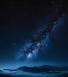 the milky shines brightly above clouds below the mountain range