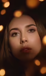 a woman is staring intently at the camera