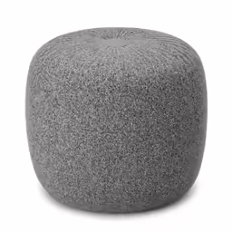 a large gray round poufy with a dark grey background