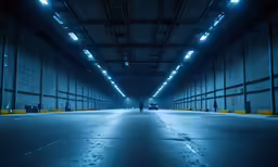 two people are standing in the dark inside a warehouse