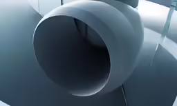 a white circular object hanging off the side of a building