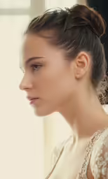 woman with a hair tie in ponytail looking into the distance