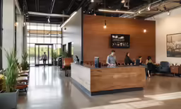 people are sitting at the front desk of an office