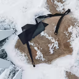 a bow is lying on top of snow