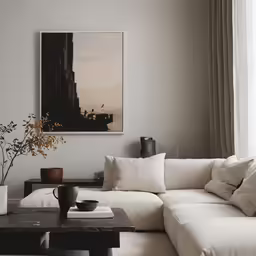 the black and white artwork hangs above a large couch