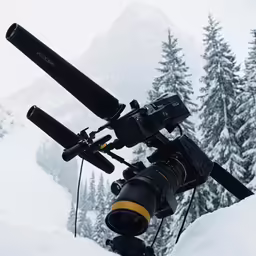 a tripod that has two large black telescopes attached to it