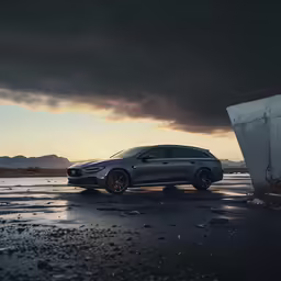 a dark grey and orange bmw x5 driving down the road