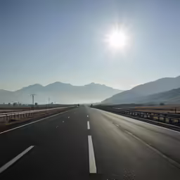 an empty highway in the middle of the mountains