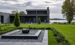 a building that has some water and grass in it