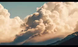 cloud over mountain with tree tops in daytime