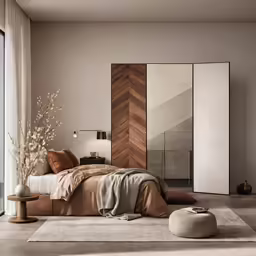 a room with a bed a vase of flowers and other decor
