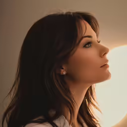 a woman that is looking out of a window