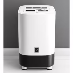 a white air conditioner in front of a grey wall