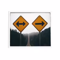 two road signs that show the opposite way