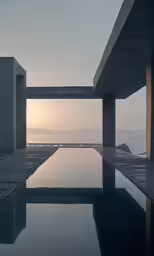 an empty pool sits in front of a large concrete structure
