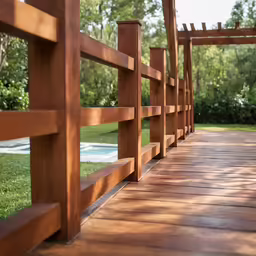 a wooden bridge across a grassy field