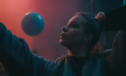 a woman in a room holding a frisbee