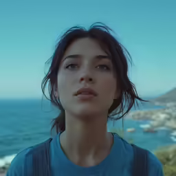 a beautiful young woman with shoulder bags looking off into the distance