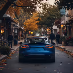 blue sports car parked on street in urban setting