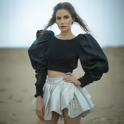 woman in a dress posing on the beach