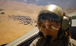 the young woman is taking off with a pilot looking on