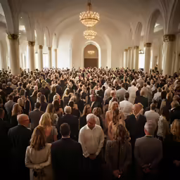 a large group of people are attending to a meeting